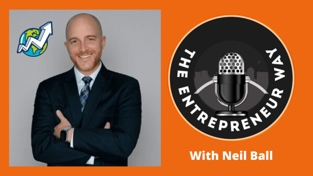 Brett smiling while crossing his arms wearing a suit white shirt, and blue tie. At his left is the Gsu logo and at his right there is an illustration of a microphone with a city at the back with the tittle The Entrepreneur Way with Neil Ball