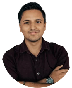 Man with a black shirt, smiling, and standing up.