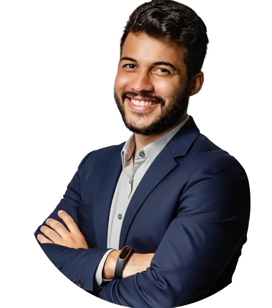Man with a blue blazer and standing up , smiling with crossed arms.
